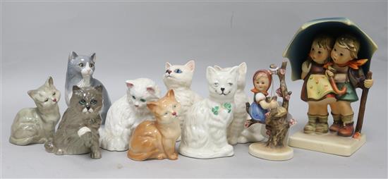 Two Hummel figures of children and a collection of cat figures by Royal Doulton, Beswick and Belleek